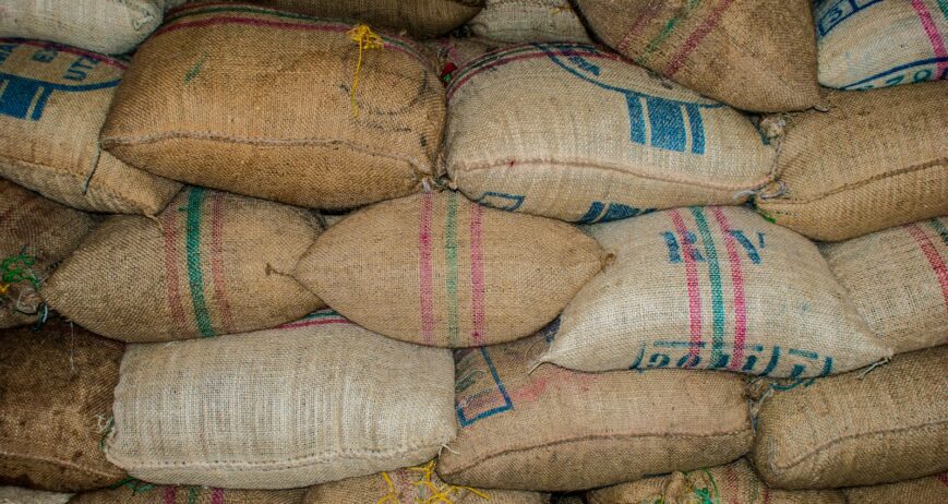Stacked jute sacks of grain in storage