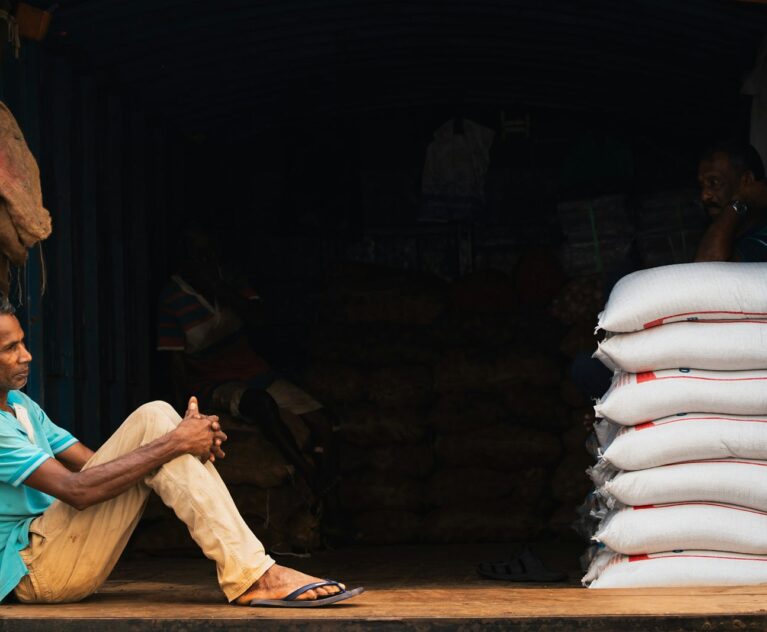 Truck loaded with stacked bags of grain for delivery under a grain supply contract