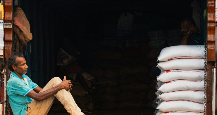 Truck loaded with stacked bags of grain for delivery under a grain supply contract