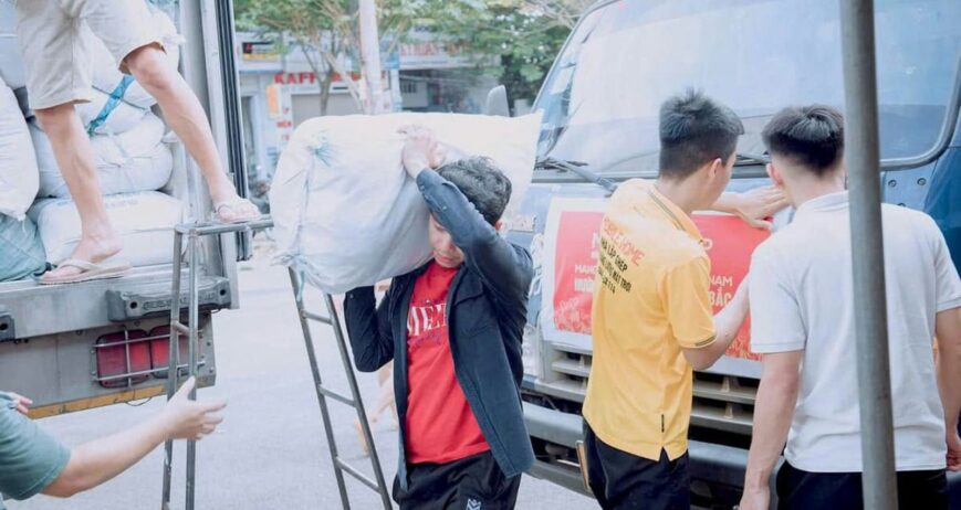 Workers loading sacks into a truck, illustrating loading unloading labour safety